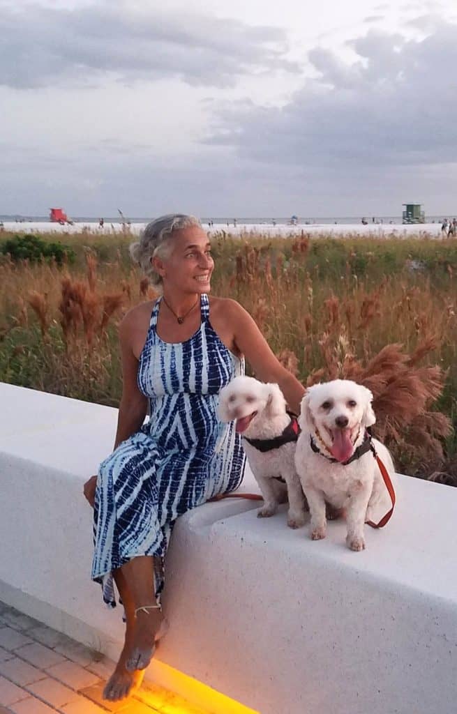 Vanda sitting on a ledge with Larah and Sage